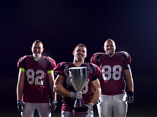 Image showing american football team with trophy celebrating victory