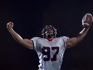 Image showing american football player celebrating after scoring a touchdown