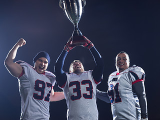 Image showing american football team with trophy celebrating victory