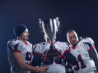 Image showing american football team with trophy celebrating victory