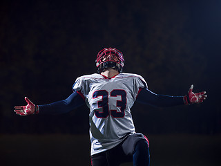 Image showing american football player celebrating after scoring a touchdown