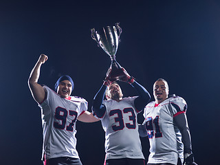 Image showing american football team with trophy celebrating victory