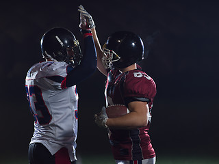 Image showing american football players celebrating after scoring a touchdown