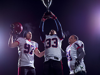 Image showing american football team with trophy celebrating victory