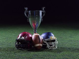 Image showing closeup of american football,helmets and trophy