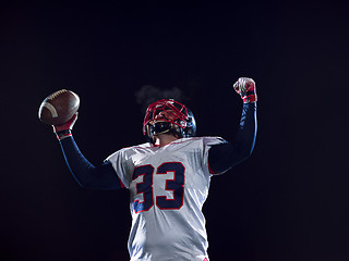 Image showing american football player celebrating after scoring a touchdown