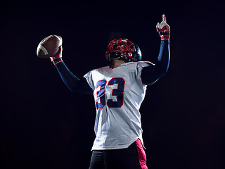 Image showing american football player celebrating after scoring a touchdown