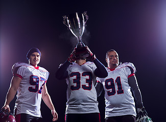 Image showing american football team with trophy celebrating victory