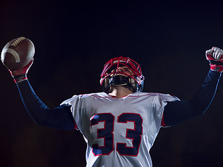 Image showing american football player celebrating after scoring a touchdown