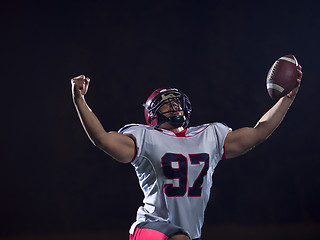 Image showing american football player celebrating after scoring a touchdown