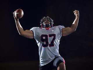 Image showing american football player celebrating after scoring a touchdown