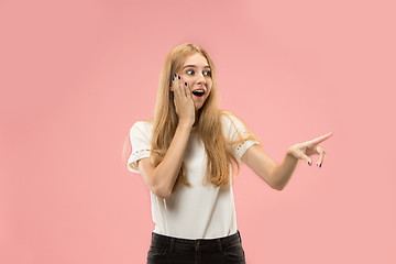 Image showing Beautiful woman looking suprised isolated on pink