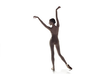 Image showing Ballerina. Young graceful female ballet dancer dancing isolated on white. Beauty of classic ballet.