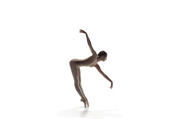 Image showing Ballerina. Young graceful female ballet dancer dancing isolated on white. Beauty of classic ballet.