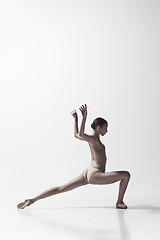 Image showing Ballerina. Young graceful female ballet dancer dancing isolated on white. Beauty of classic ballet.