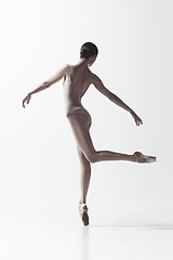 Image showing Ballerina. Young graceful female ballet dancer dancing isolated on white. Beauty of classic ballet.