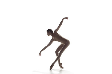 Image showing Ballerina. Young graceful female ballet dancer dancing isolated on white. Beauty of classic ballet.