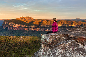 Image showing Woman taking in early morning mountain views