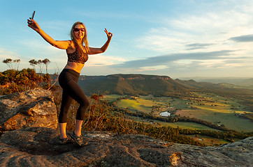 Image showing The selfie generation a tourist at lookout taking photo