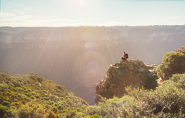 Image showing Mountain explorer taking in views from a rock precipice