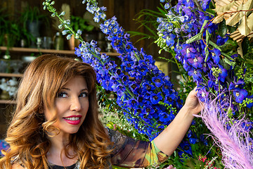 Image showing Florist  shop owner or customer outside with flower displays