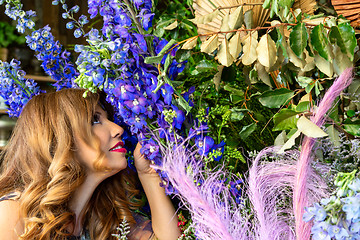 Image showing Customer smelling and admiring flowers at a florist shop