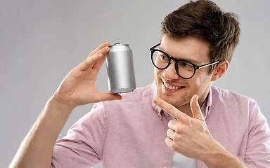 Image showing happy young man holding tin can with soda