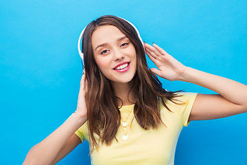 Image showing happy young woman or teenage girl with headphones