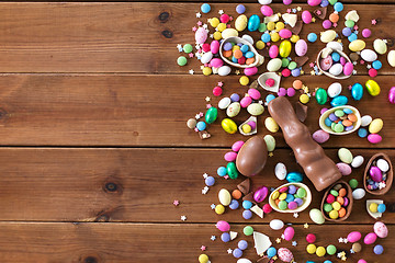 Image showing chocolate eggs, easter bunny and candies on wood