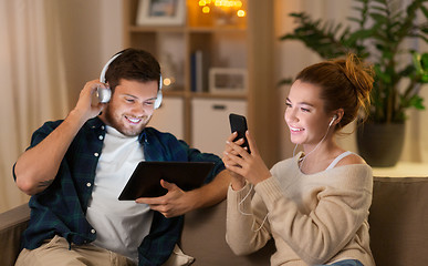 Image showing couple with gadgets listening to music at home