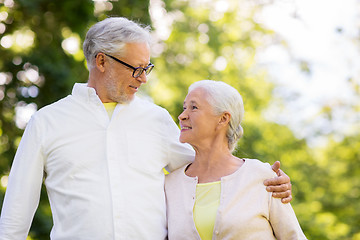 Image showing happy senior couple hugging at summer park