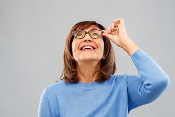 Image showing portrait of senior woman in glasses looking up