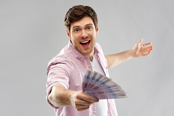 Image showing happy young man with fan of euro money