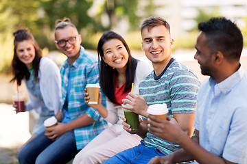 Image showing friends drinking coffee and juice talking in city