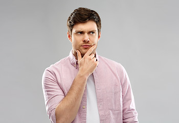 Image showing young man thinking and looking up