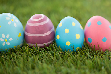 Image showing row of colored easter eggs on artificial grass