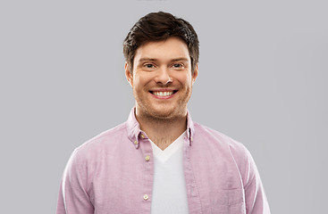 Image showing smiling young man over grey background