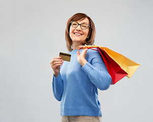 Image showing senior woman with shopping bags and credit card