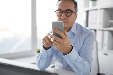 Image showing businessman using smartphone at office