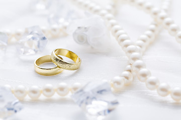 Image showing Two golden rings with pearl necklace and on white background