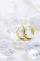 Image showing Two golden rings with pearl necklace and on white background