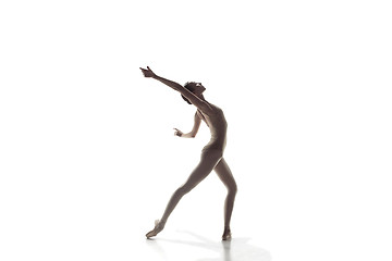 Image showing Ballerina. Young graceful female ballet dancer dancing isolated on white. Beauty of classic ballet.