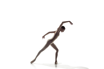 Image showing Ballerina. Young graceful female ballet dancer dancing isolated on white. Beauty of classic ballet.