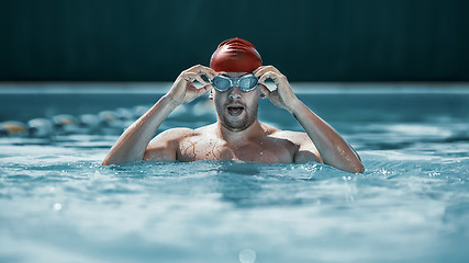 Image showing fit swimmer in cap at pool