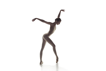 Image showing Ballerina. Young graceful female ballet dancer dancing isolated on white. Beauty of classic ballet.