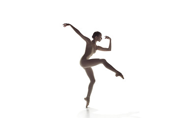 Image showing Ballerina. Young graceful female ballet dancer dancing isolated on white. Beauty of classic ballet.