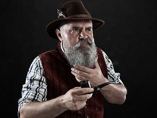 Image showing dramatic portrait of senior smoking tobacco pipe