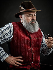 Image showing dramatic portrait of senior smoking tobacco pipe