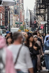 Image showing New York, NY, USA - May 17, 2018: Crowds of people walking sidewalk of Broadway avenue in Soho of Midtown Manhattan on may 17th, 2018 in New York City, USA.