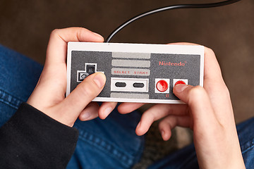 Image showing Nintengo NES,playing Super Mario 3